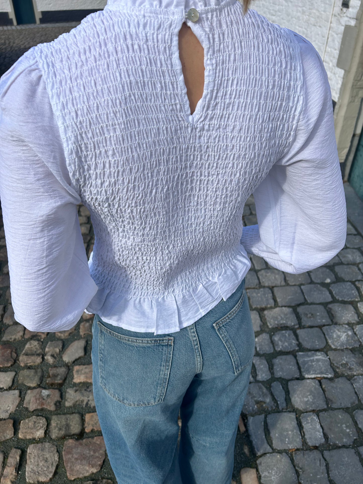 White ruffle blouse